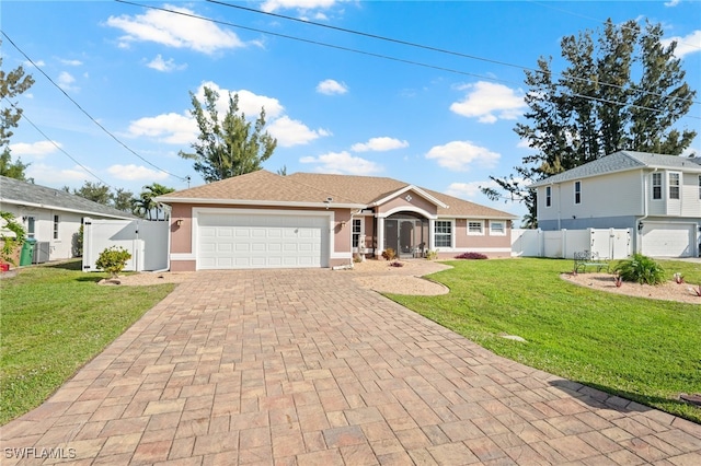 single story home with an attached garage, fence, decorative driveway, stucco siding, and a front yard