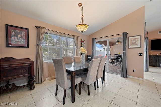 dining room with lofted ceiling, light tile patterned flooring, and baseboards