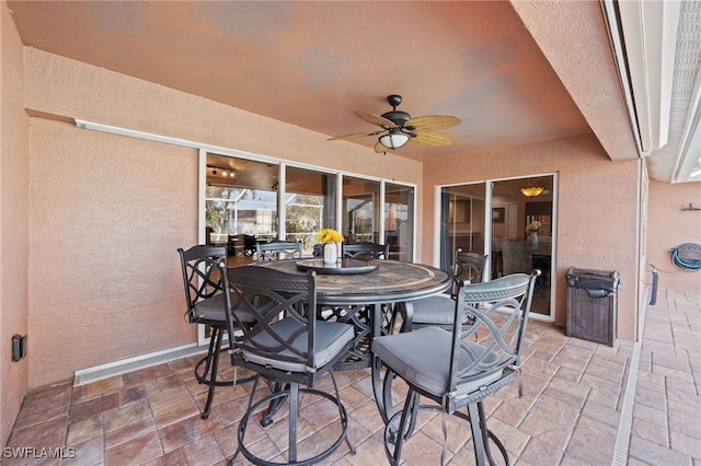 view of patio / terrace with outdoor dining area and a ceiling fan