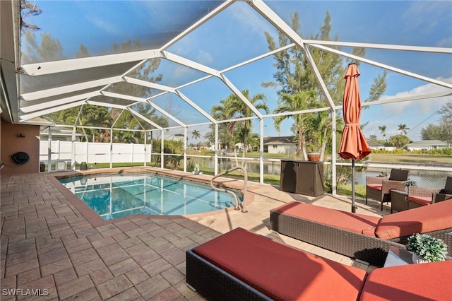 view of swimming pool featuring glass enclosure, a patio, and fence