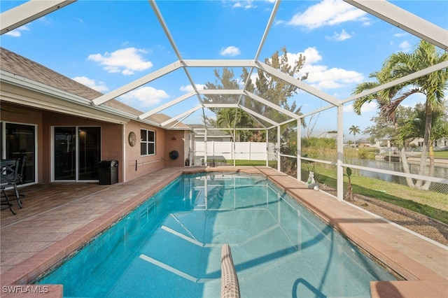 view of swimming pool featuring a fenced in pool, a patio, glass enclosure, a water view, and fence