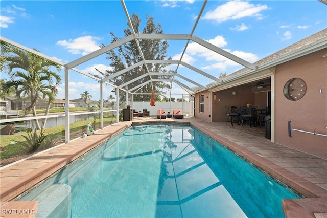 view of pool with a patio area, a water view, a lanai, and a fenced in pool