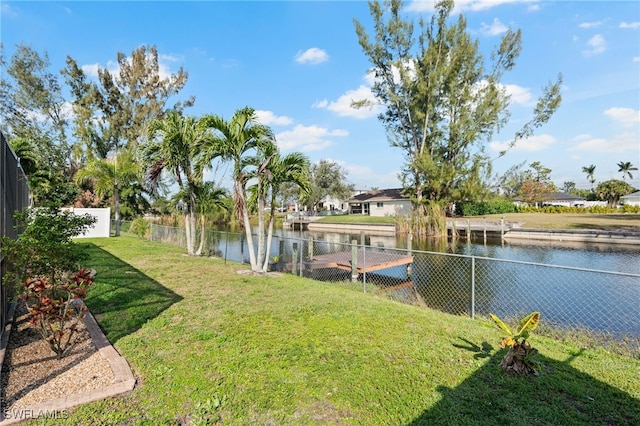 view of yard with a water view and fence