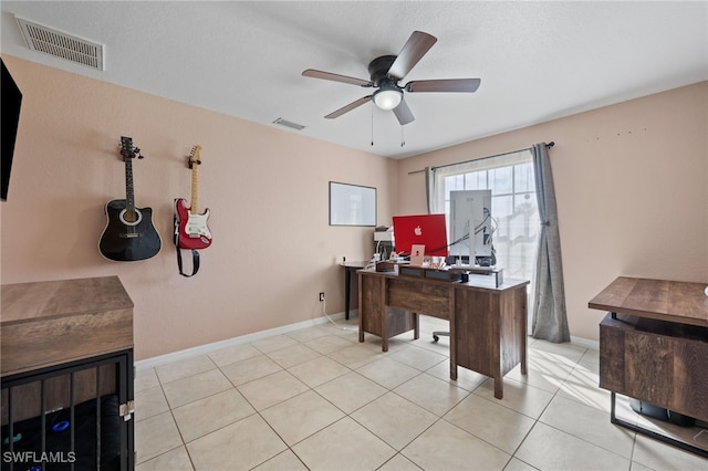 office with light tile patterned floors, ceiling fan, visible vents, and baseboards