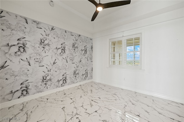 unfurnished room with marble finish floor, ceiling fan, ornamental molding, and baseboards