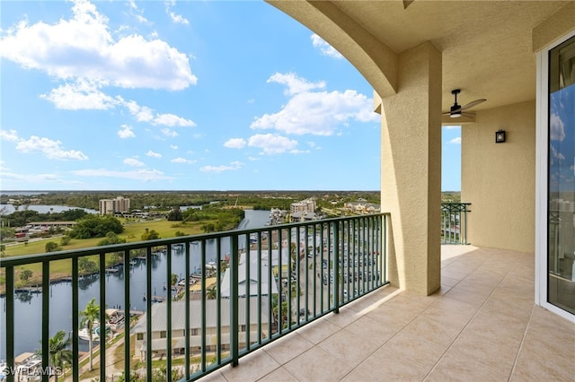 balcony featuring a ceiling fan and a water view