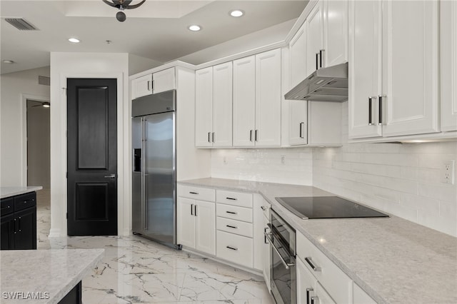 kitchen featuring appliances with stainless steel finishes, white cabinets, and under cabinet range hood