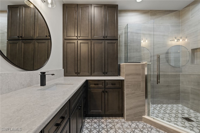 bathroom featuring a stall shower, tile patterned flooring, and vanity