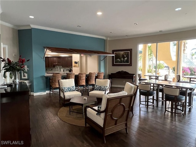 dining space featuring ornamental molding, dark wood finished floors, and recessed lighting