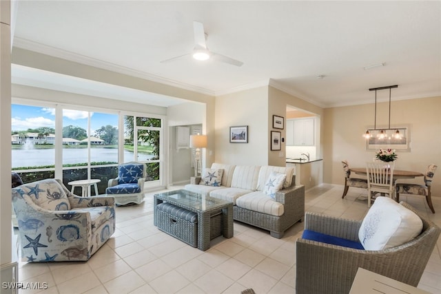 living area featuring light tile patterned flooring, a water view, a ceiling fan, baseboards, and ornamental molding