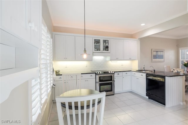 kitchen featuring range with two ovens, dark countertops, black dishwasher, and white cabinets