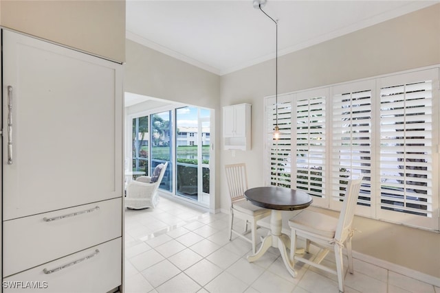 dining area featuring ornamental molding, light tile patterned flooring, and baseboards