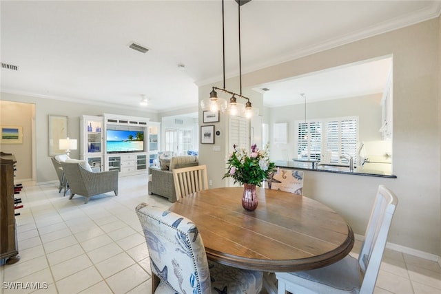 dining space featuring visible vents, crown molding, baseboards, and light tile patterned floors