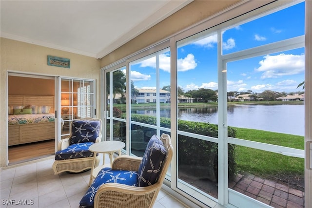 sunroom featuring a water view