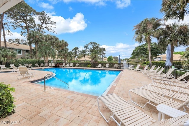 community pool featuring a patio area and fence