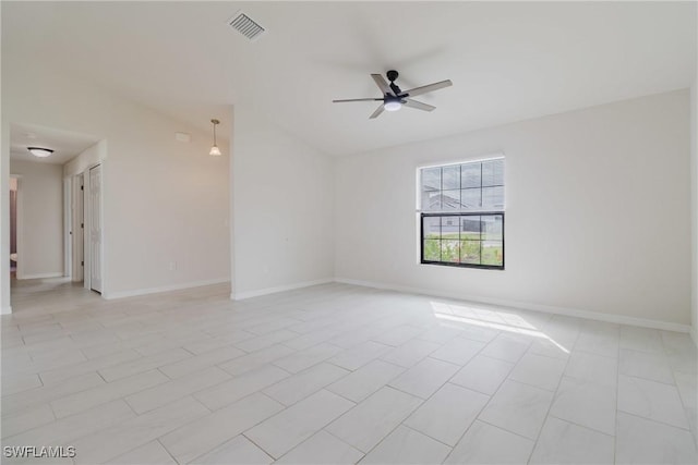 empty room with baseboards, a ceiling fan, and visible vents