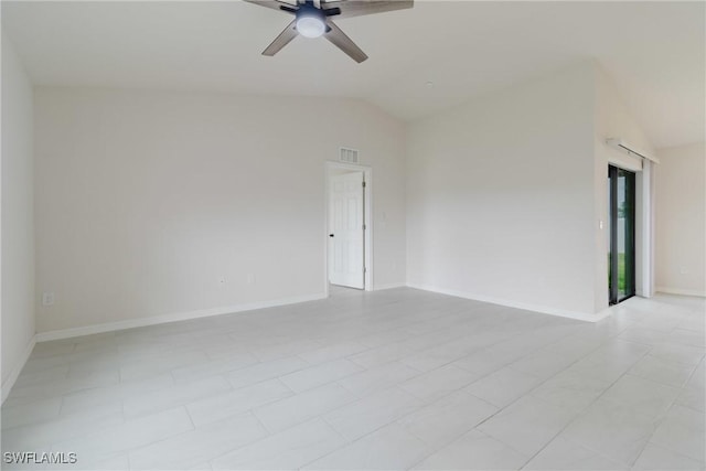 empty room featuring baseboards, visible vents, lofted ceiling, and a ceiling fan