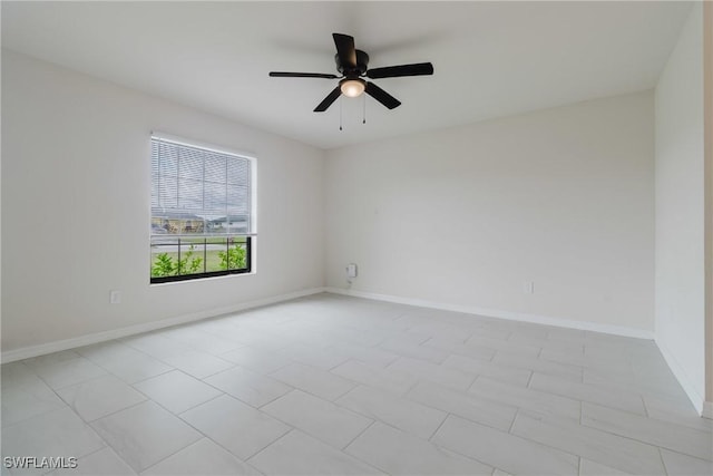 empty room featuring baseboards and a ceiling fan