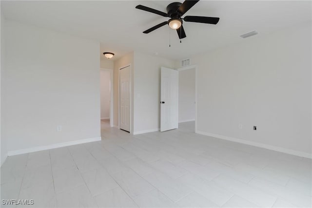 unfurnished room with baseboards, ceiling fan, and visible vents