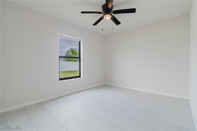 unfurnished room with baseboards and ceiling fan