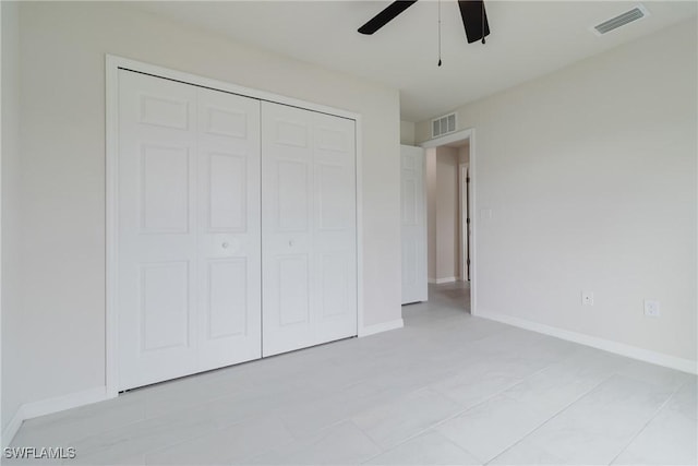 unfurnished bedroom featuring baseboards, visible vents, and a closet