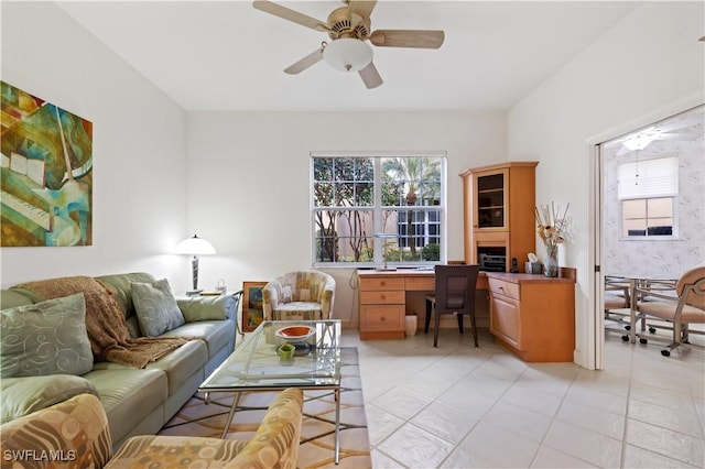 living room featuring light tile patterned floors and ceiling fan