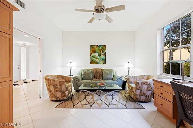 living area with light tile patterned floors, visible vents, and a ceiling fan