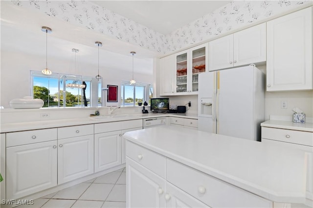 kitchen featuring wallpapered walls, white appliances, glass insert cabinets, and a sink