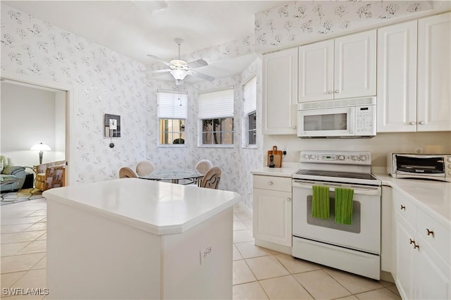 kitchen with a toaster, white appliances, and wallpapered walls