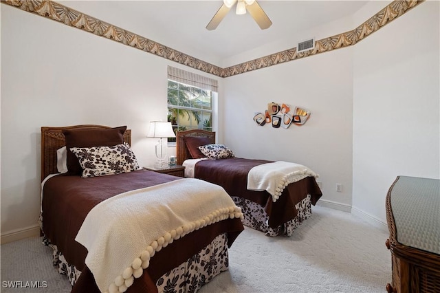 carpeted bedroom featuring a ceiling fan, baseboards, and visible vents