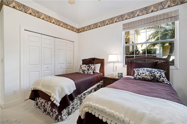 carpeted bedroom with a closet and ceiling fan