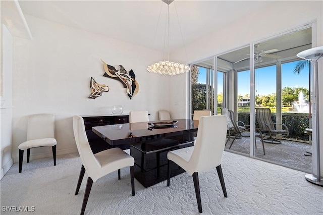 dining room with an inviting chandelier, carpet flooring, and baseboards