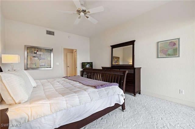 carpeted bedroom featuring baseboards, visible vents, and ceiling fan