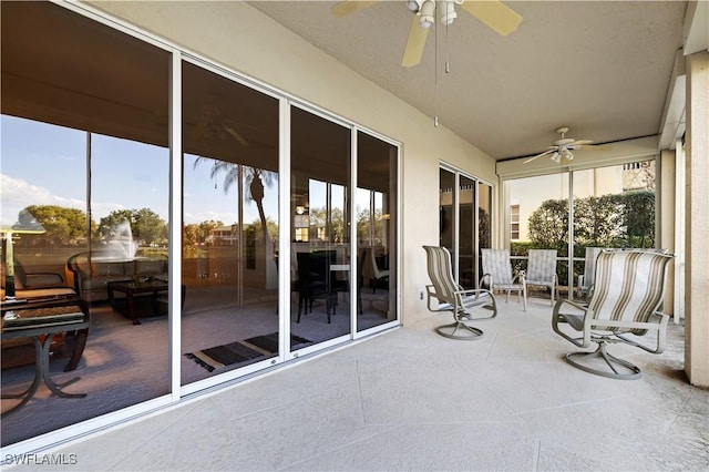 sunroom / solarium with a ceiling fan