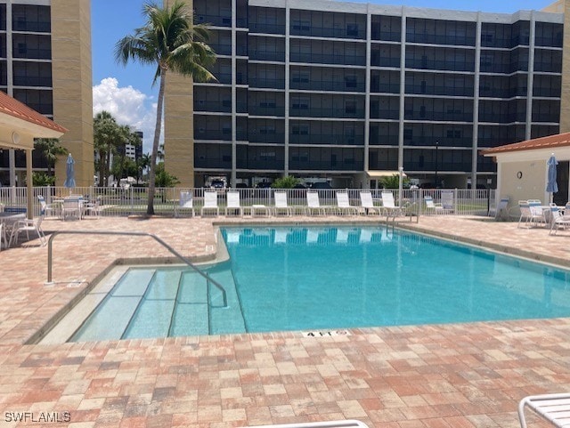 pool featuring a patio and fence