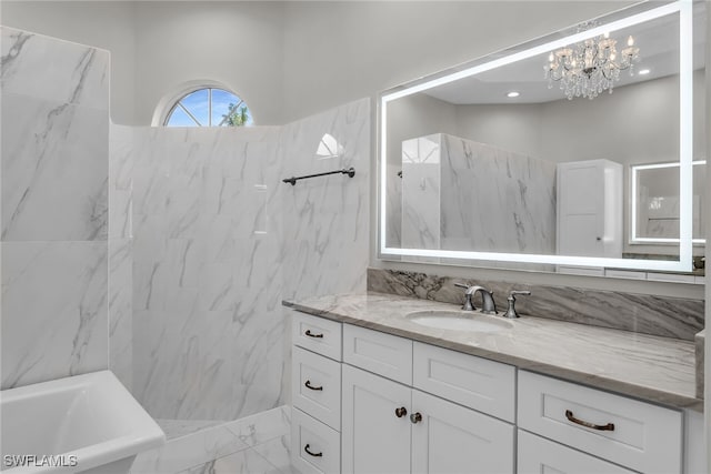 full bath with a soaking tub, vanity, and marble finish floor