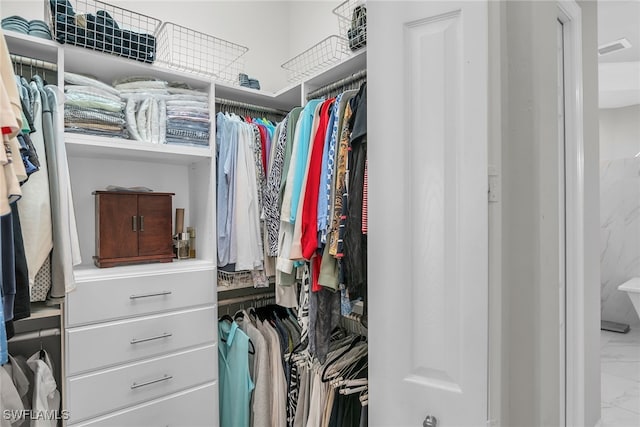 spacious closet with marble finish floor and visible vents