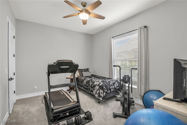 carpeted bedroom with ceiling fan and baseboards