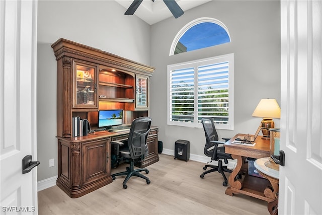 office area with light wood-style flooring, baseboards, and a ceiling fan