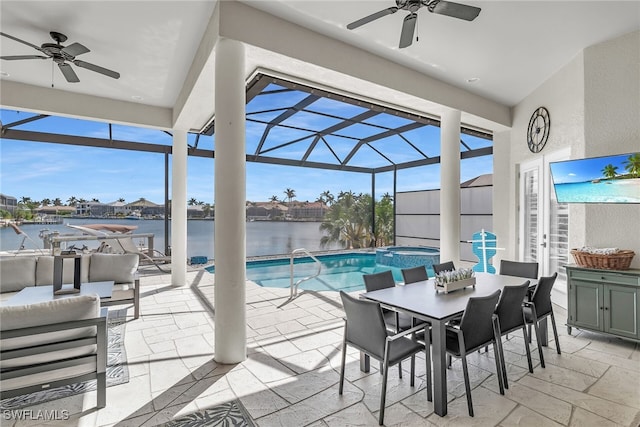 view of patio featuring glass enclosure, ceiling fan, a pool with connected hot tub, and outdoor dining space