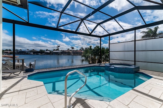 view of pool featuring a patio area, a water view, and a pool with connected hot tub