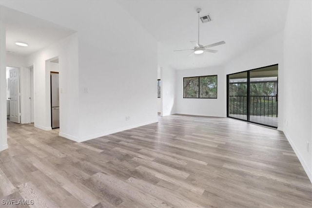 unfurnished living room featuring visible vents, light wood-style flooring, and baseboards