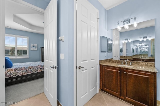 bathroom featuring tile patterned flooring, vanity, and ensuite bath