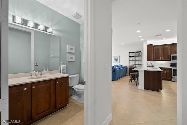 ensuite bathroom with toilet, tile patterned flooring, visible vents, and recessed lighting