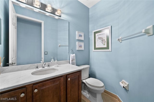 bathroom featuring vanity, toilet, and tile patterned floors