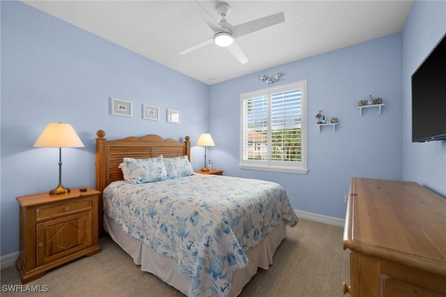 bedroom with light carpet, ceiling fan, and baseboards