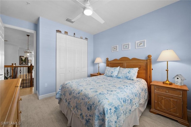 bedroom featuring light carpet, baseboards, visible vents, ceiling fan, and a closet