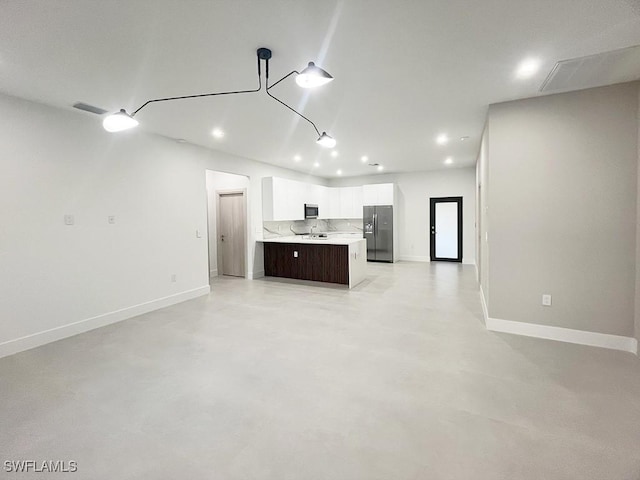 unfurnished living room with baseboards, finished concrete floors, visible vents, and recessed lighting