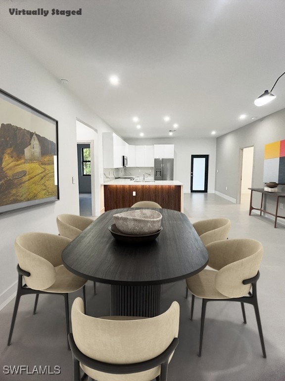 dining area featuring baseboards and recessed lighting