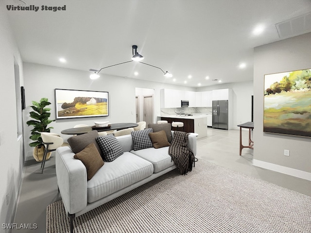 interior space with recessed lighting, visible vents, finished concrete flooring, and baseboards